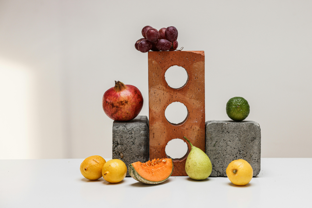 Arrangement of Different Kinds of Fruit on Concrete Blocks