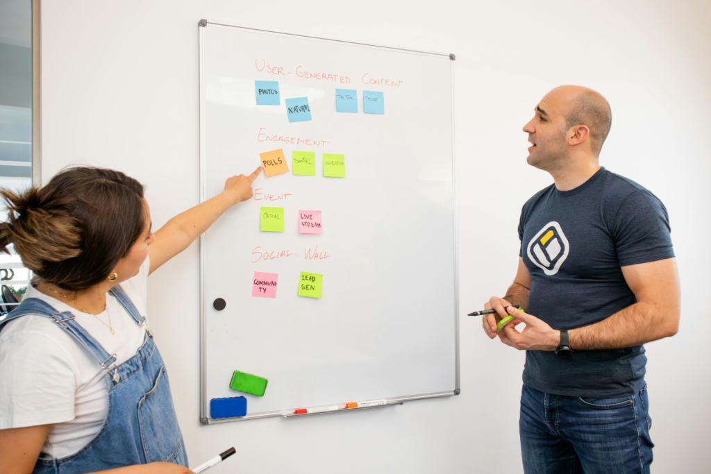 Woman and Man Working on Whiteboard