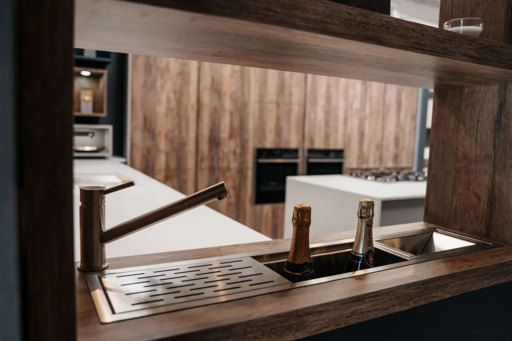 a photo of some time bottles and a tap in a kitchen