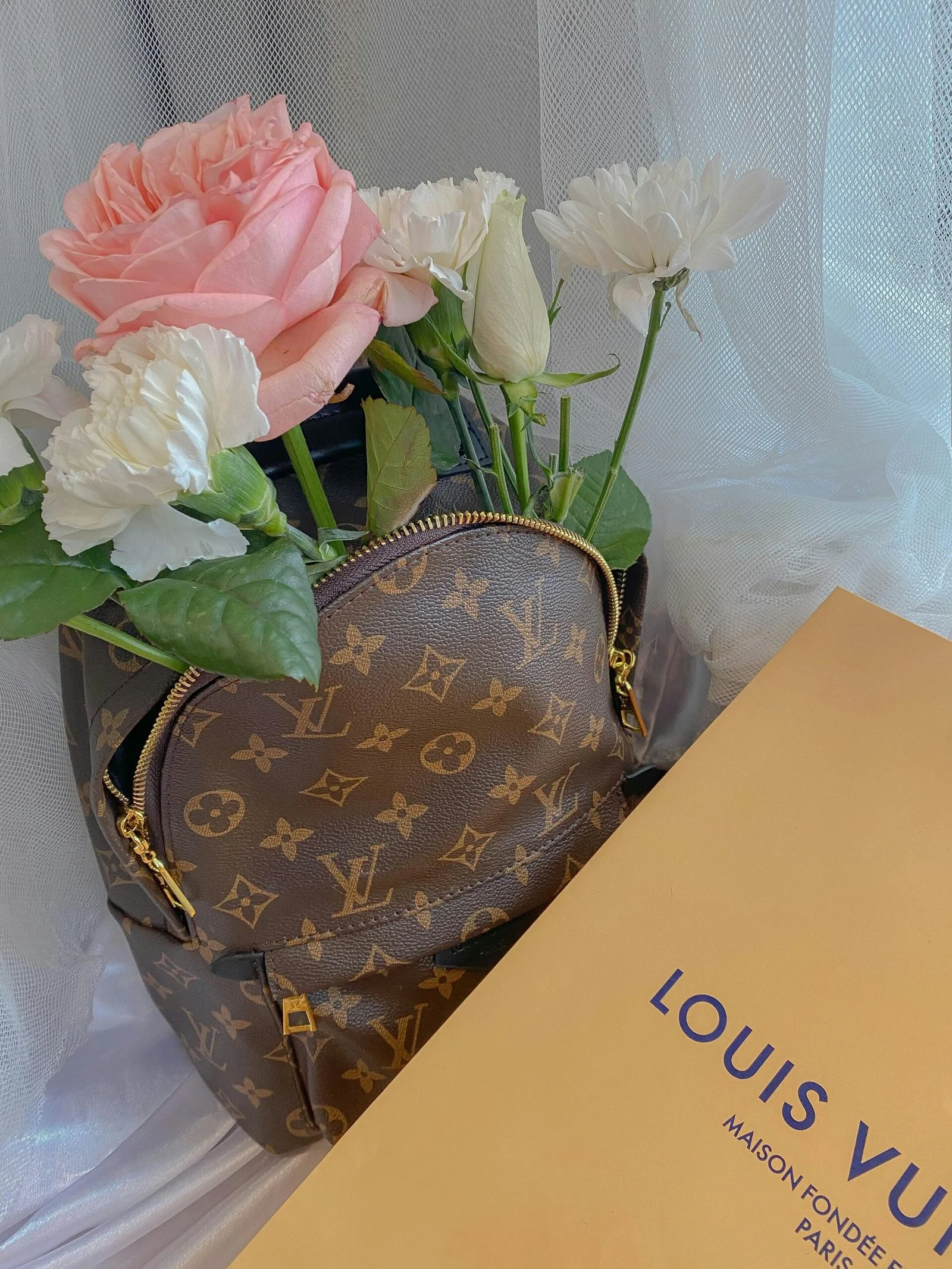 a louis vuitton bag with roses inside