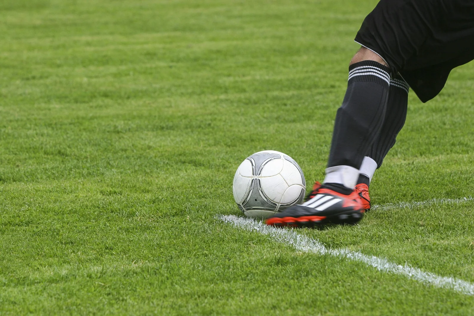 someone kicking a football