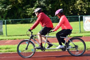 An image of a man and a woman on a bike